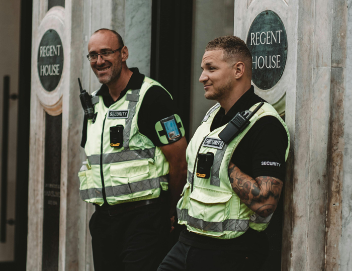 Two security guards smiling at the camera